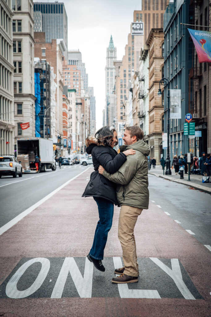 guy holding a girl on broadway street in soho in the fall