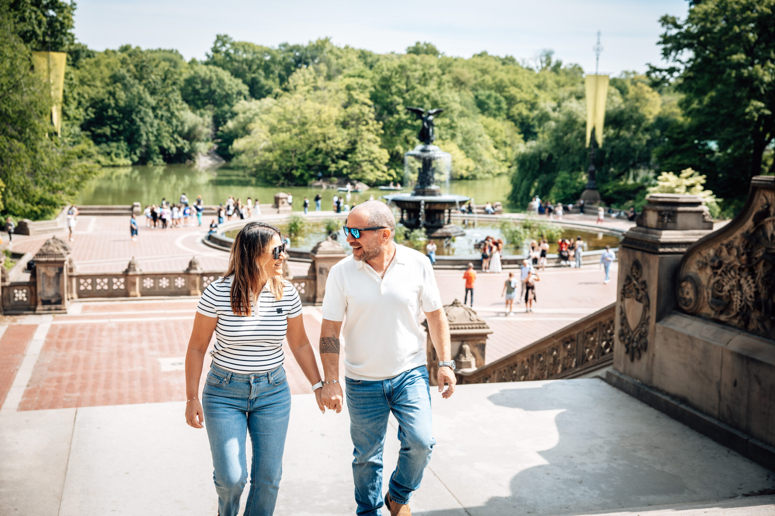 couple smiling together in Central Park by Bethesda terrance nyc