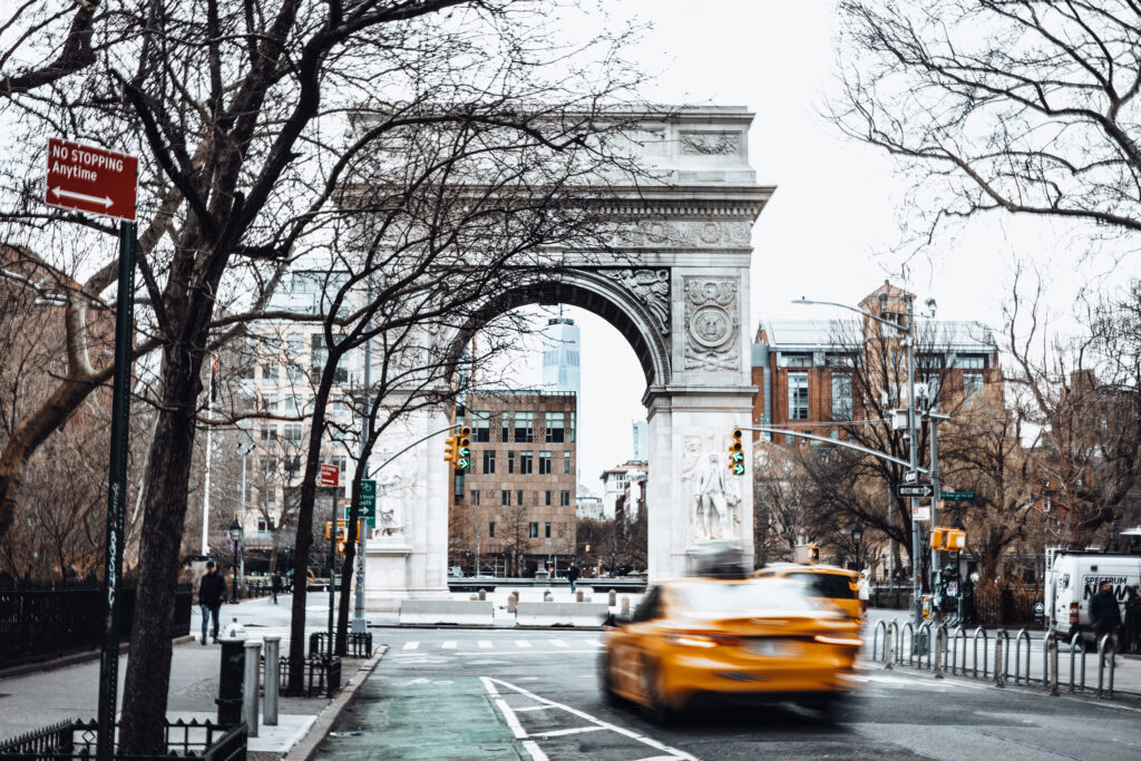 greenwich village and the Washington square arch with a yellow cab